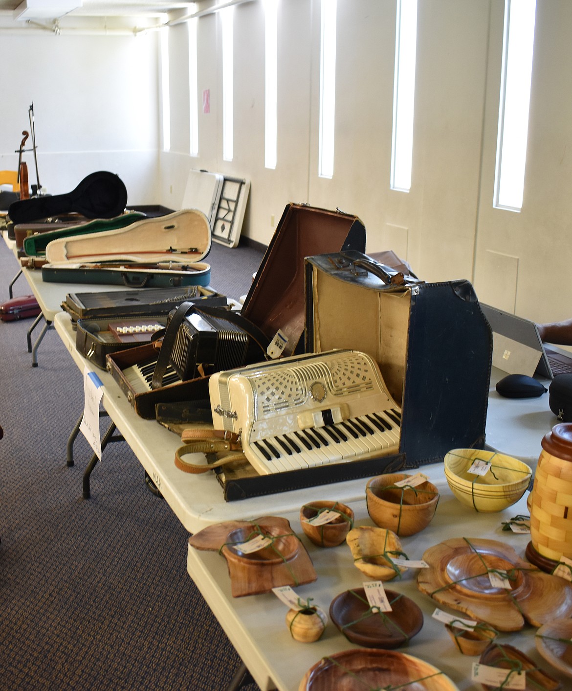 Used instruments are offered for sale at the fiddle camp. Other things offered are art projects, CDs by students and teachers and, this year, a huge quantity of old sheet music donated by Co-Chair Corinne Agnew from her grandmother’s collection.