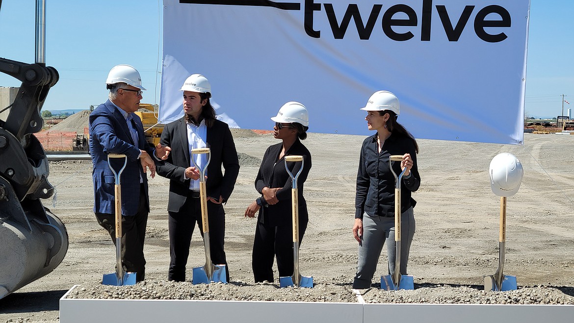 Washington Governor Jay Inslee, left, speaks with Twelve cofounders, from left to right, Nicholas Flanders, Etosha Cave and Kendra Kuhl during the Twelve groundbreaking on Tuesday. The facility south of Wheeler Road and east of Moses Lake will develop and produce environmentally friendly aviation fuel.