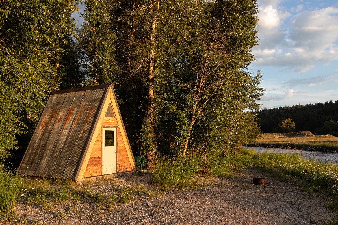 The A-Frame cabin sits next to the Tobacco River during golden hour on the Tobacco River Ranch in Eureka. (Kate Heston/Daily Inter Lake)