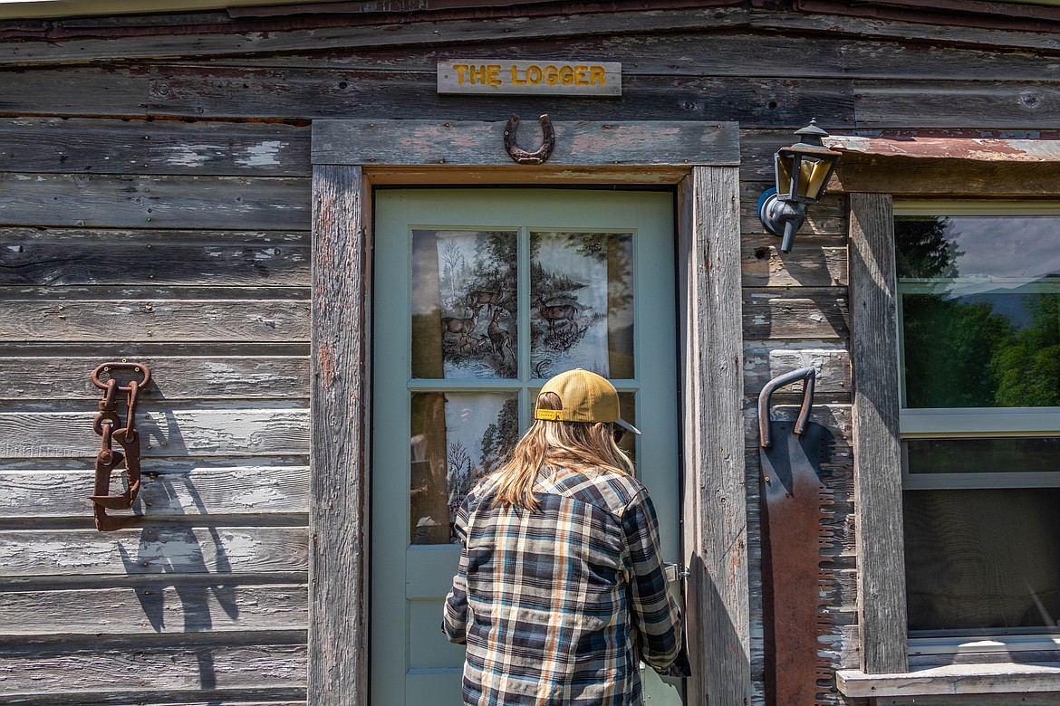 Nikki Eisinger enters "The Logger" cabin, which is made out of an old loggers cabin, at the Tobacco River Ranch at the end of June 2023. (Kate Heston/Daily Inter Lake)
