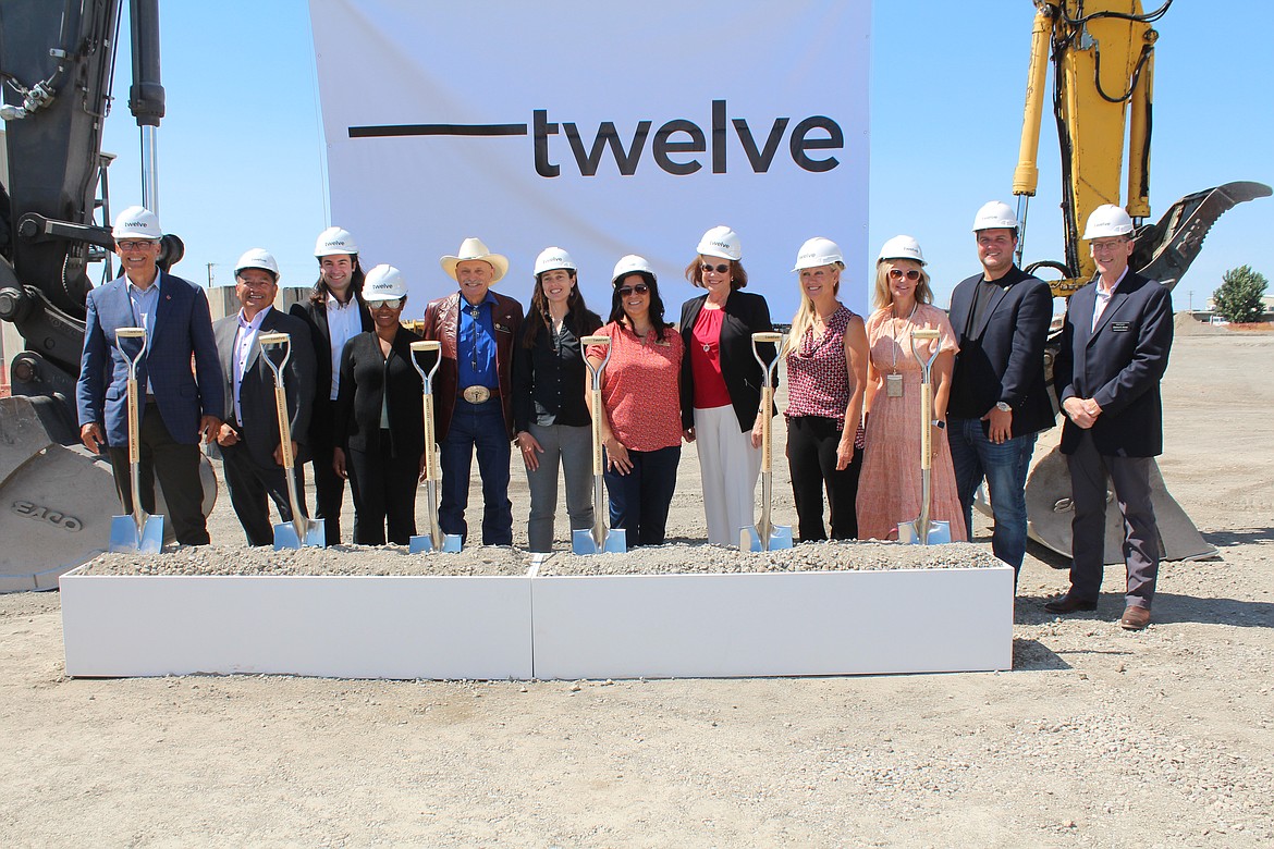 Twelve cofounders and government officials posed for a picture at the company’s groundbreaking ceremony Tuesday.