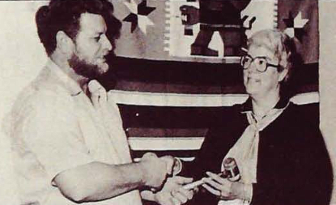 In 1982, Magistrate Virginia Balser gifts a gavel to NIC Student Body President Jim Brewer.