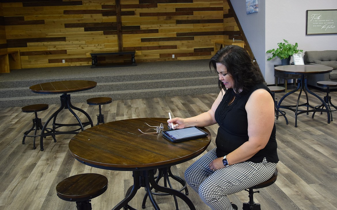 Lighthouse Cafe’s new program director, Angela Kudsk, works in the cafe’s main room on planning the many partnerships and programs she intends to implement for the cafe.