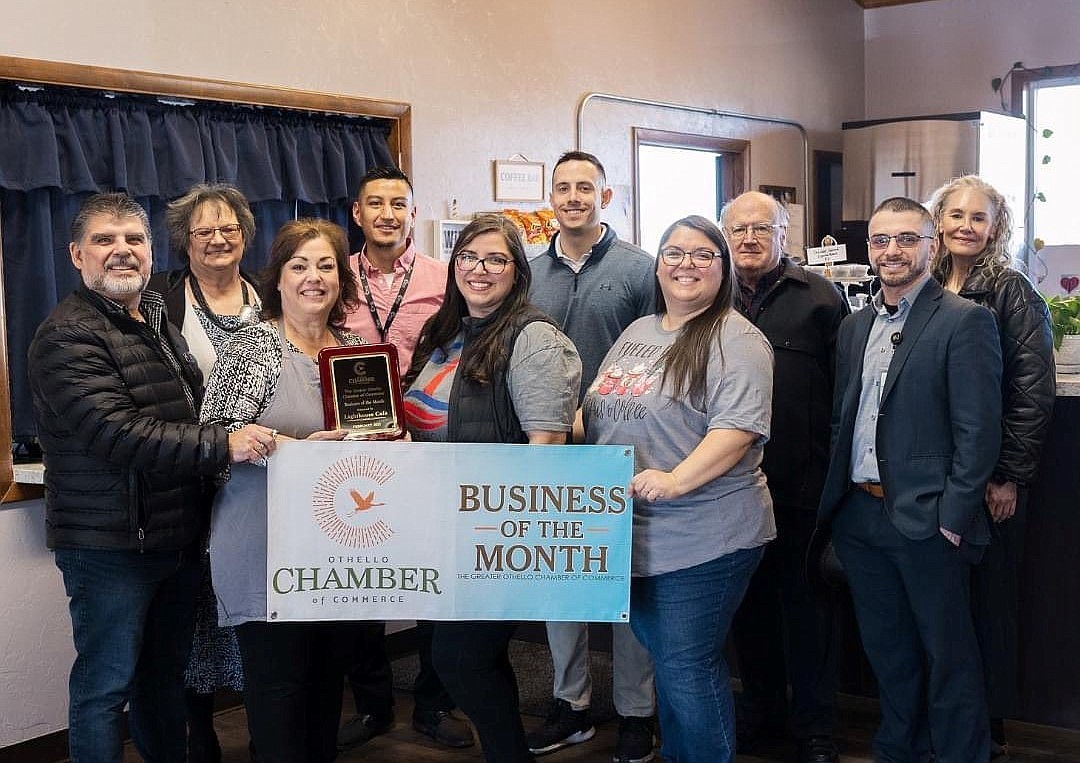 In a row in front of Othello Chamber of Commerce members, Lighthouse Café crew members Samuel Garza, Rosa Garza, Samantha Garza and Crystal Garza hold a plaque and banner announcing Lighthouse as the Chamber of Commerce’s business of the month for February 2023.