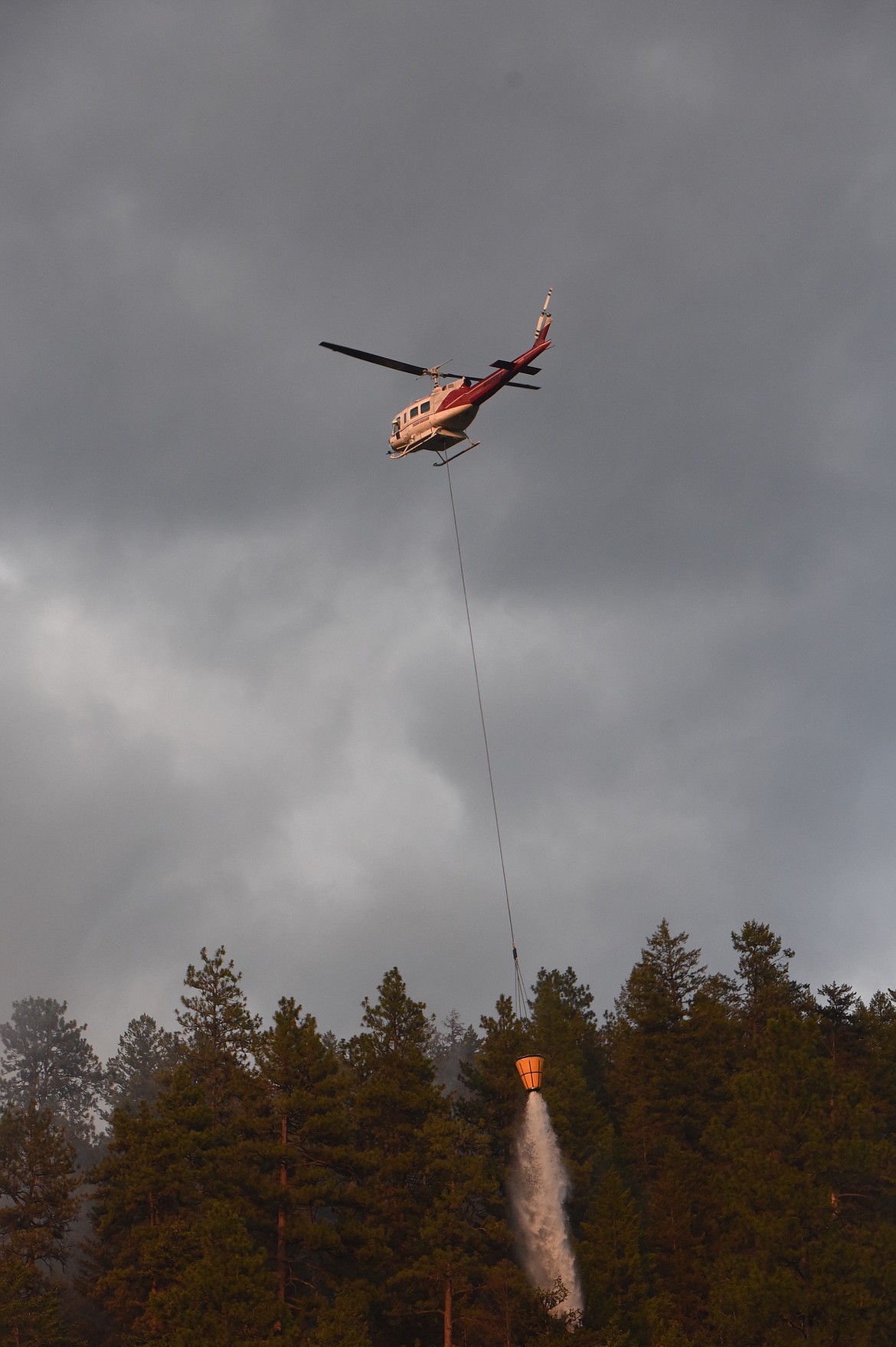 Two helicopters and a plane aided firefighters who responded to two wild fires located just off Jennings Haul Road Thursday evening. (Scott Shindledecker/The Western News)