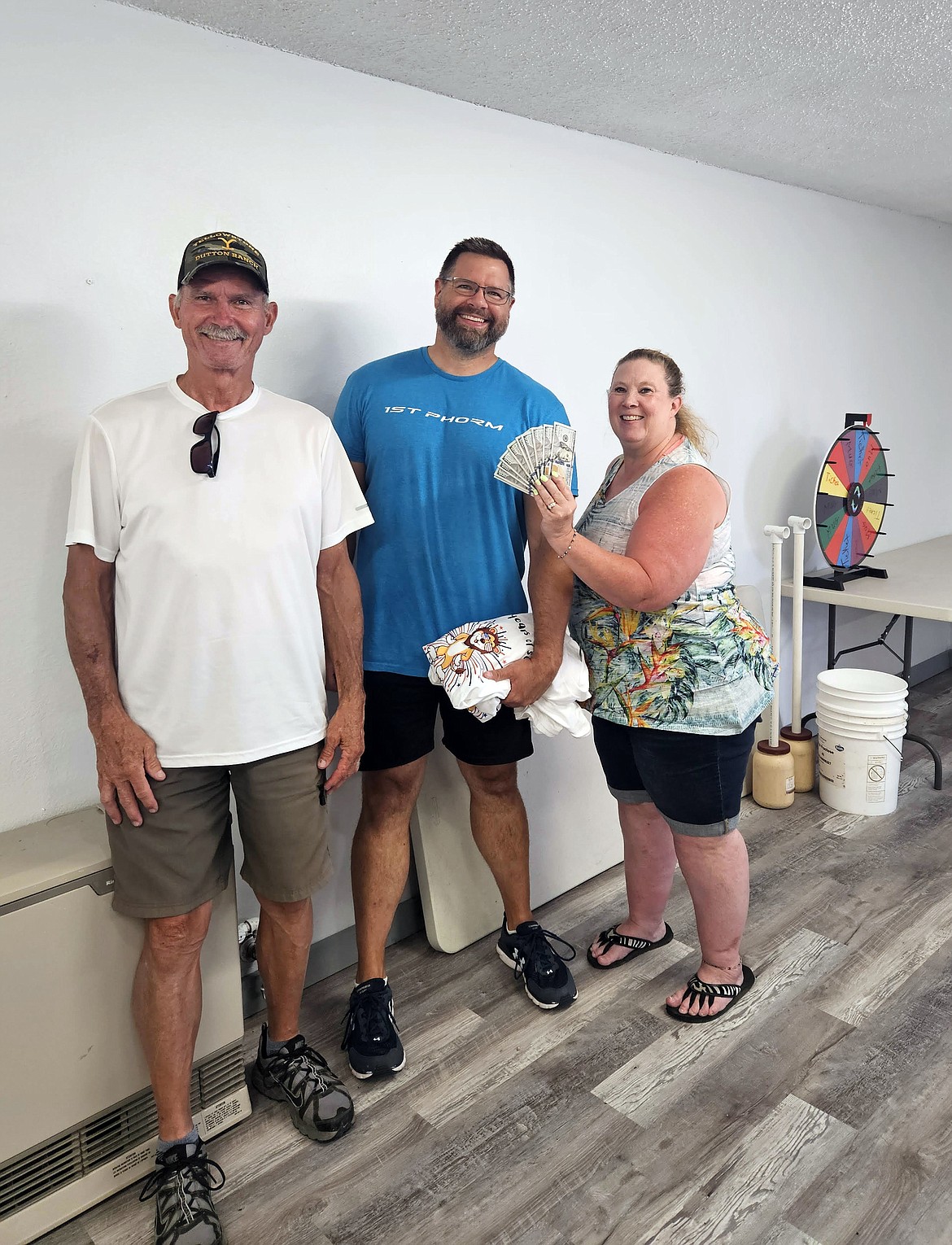 Chris Harris, center, is the winner of $1,000 in cash after his ticket was selected for the second-place prize in the Sandpoint Lions Fourth of July raffle. Pictured with Harris are Sandpoint Lions Paul and Gina Gregory.