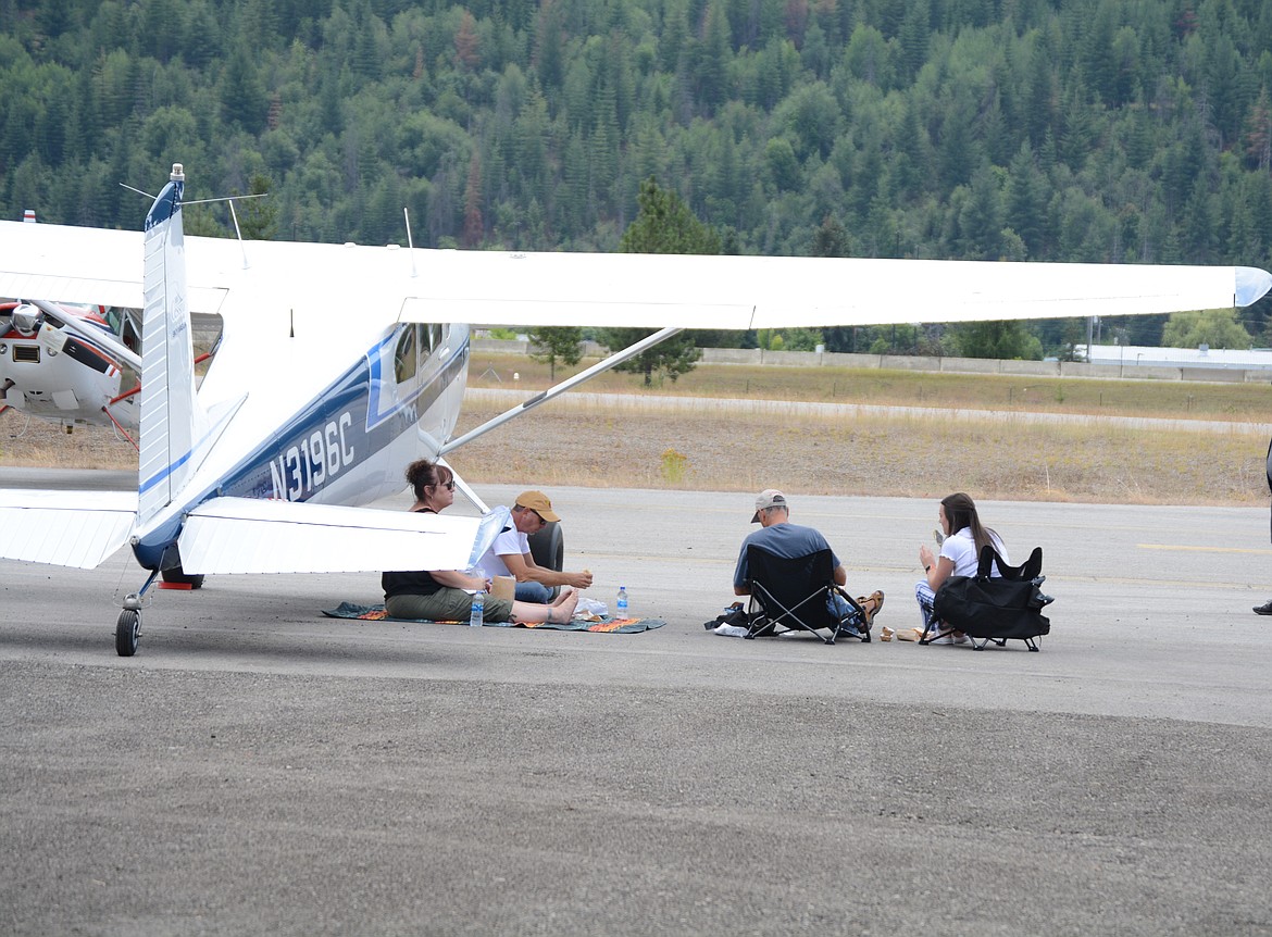 Flyers eat lunch under the wing of a Cessna during the Puget Sound Antique Airplane Club air tour stop in Shoshone County airport.

30 planes visited the airport Tuesday morning and were greeted by a crowd of locals during a stop.