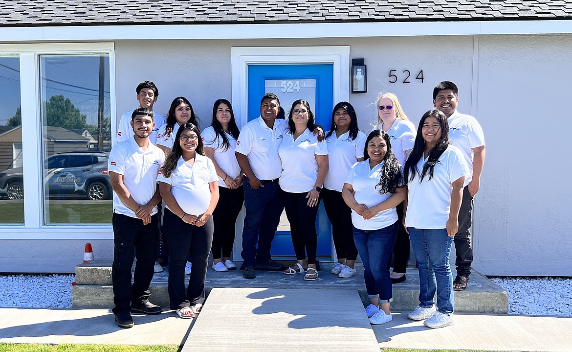 Heavenly Roofing owners Victor and Yuritzi Chavez, center, and their staff will offer a free roof to some local veteran this year.