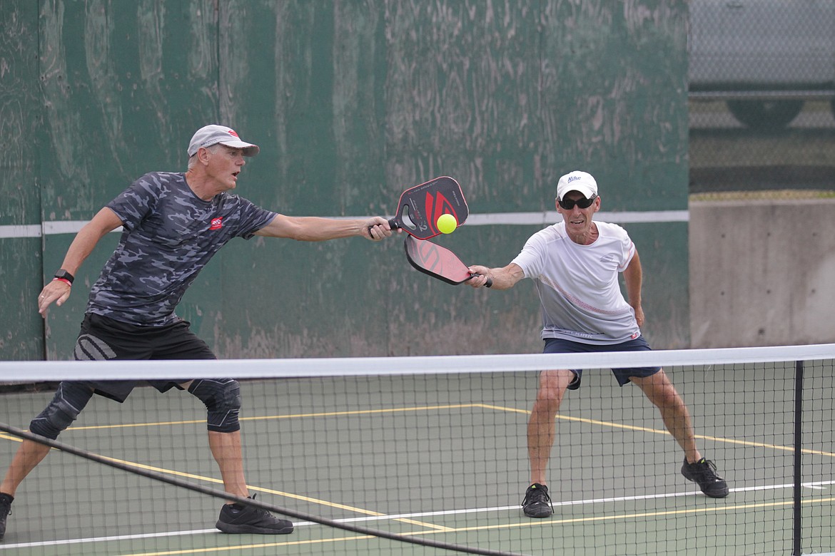 MARK NELKE/Press
Lee Paul, left, of Newman Lake, Wash., and his partner Dave Allen of Spokane reach for a shot in a men's doubles match Thursday at the Coeur d'Alene Classic pickleball tournament at Cherry Hill Park.