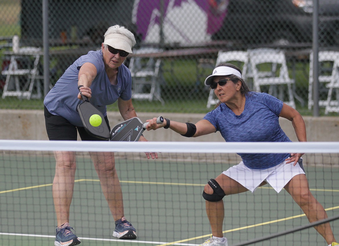 MARK NELKE/Press
Marian Rust, left, of Sandpoint, and her partner Joann Angle of Greenacres, Wash., reach for a shot during a women's doubles match Thursday at the Coeur d'Alene Classic pickleball tournament at Cherry Hill Park.