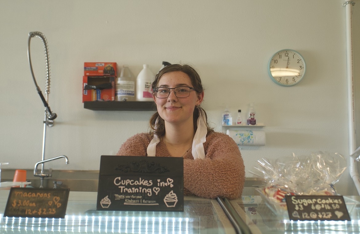 Aurora Doll stands behind a bakery display case in her business, 406 Cakes & Cravings. The 17-year old has been a lifelong Polson resident with a zest for serving up cakes in the Mission Valley. (Max Dupras/Leader)