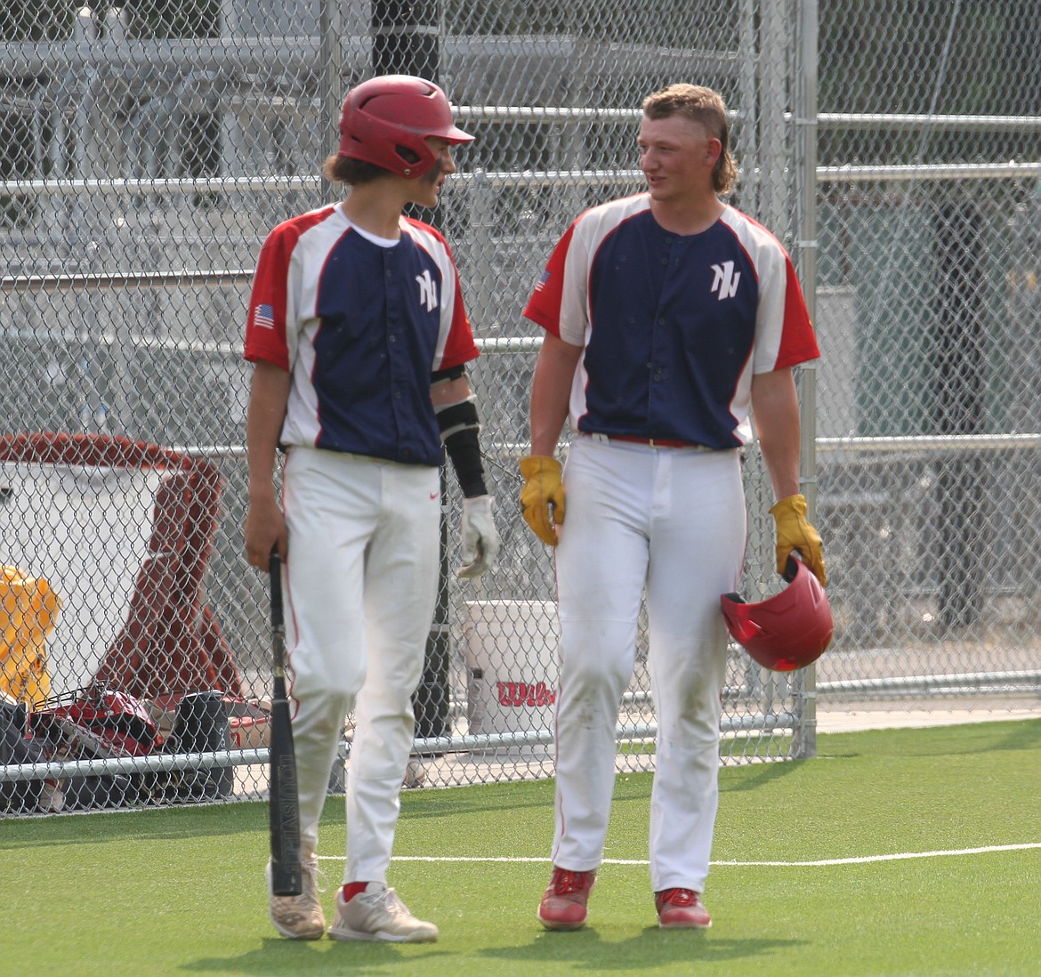 Sage Medeiros, left, chats with Zeke Roop during a Camas Prairie pitching change.