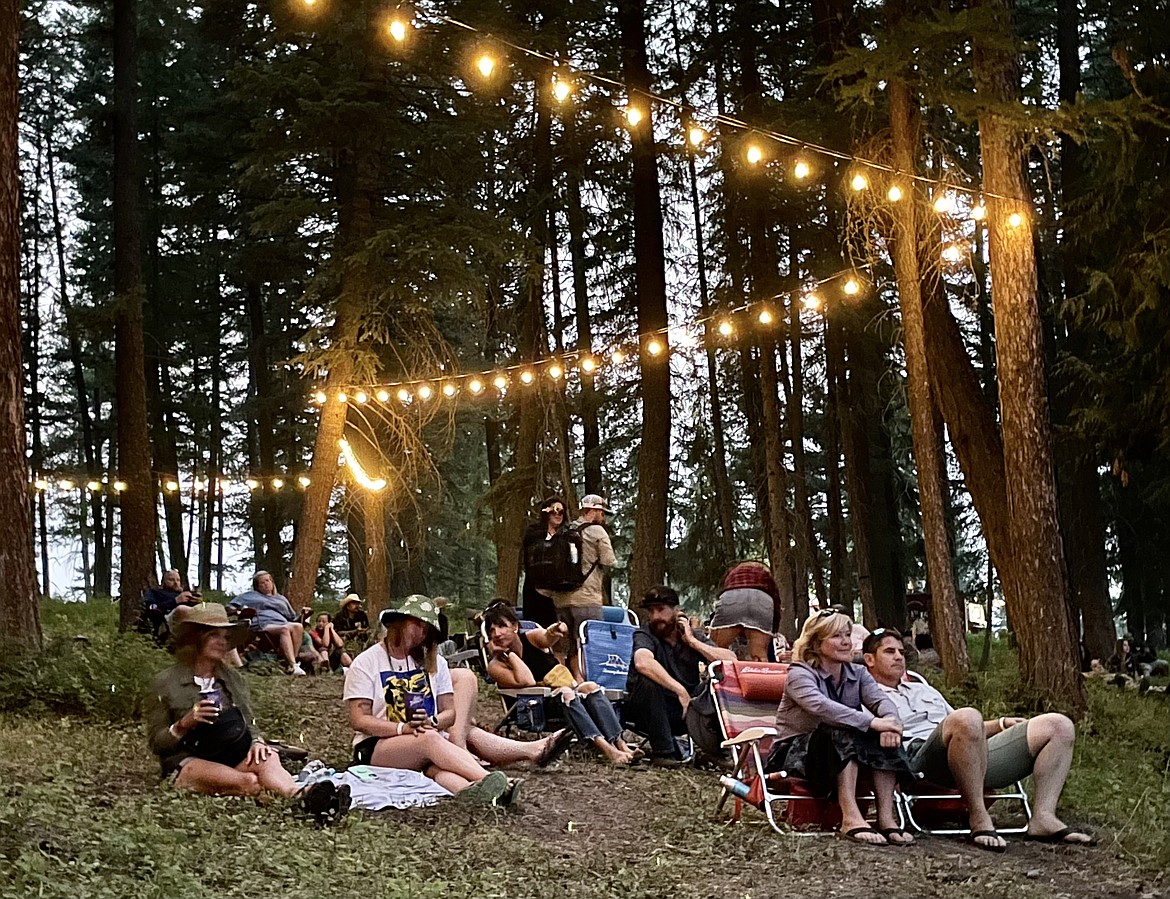 People watch Caamp from a forested area of Big Mountain Ranch at the Under the Big Sky music festival in Whitefish on Friday, July 14, 2023. (Matt Baldwin/Daily Inter Lake)