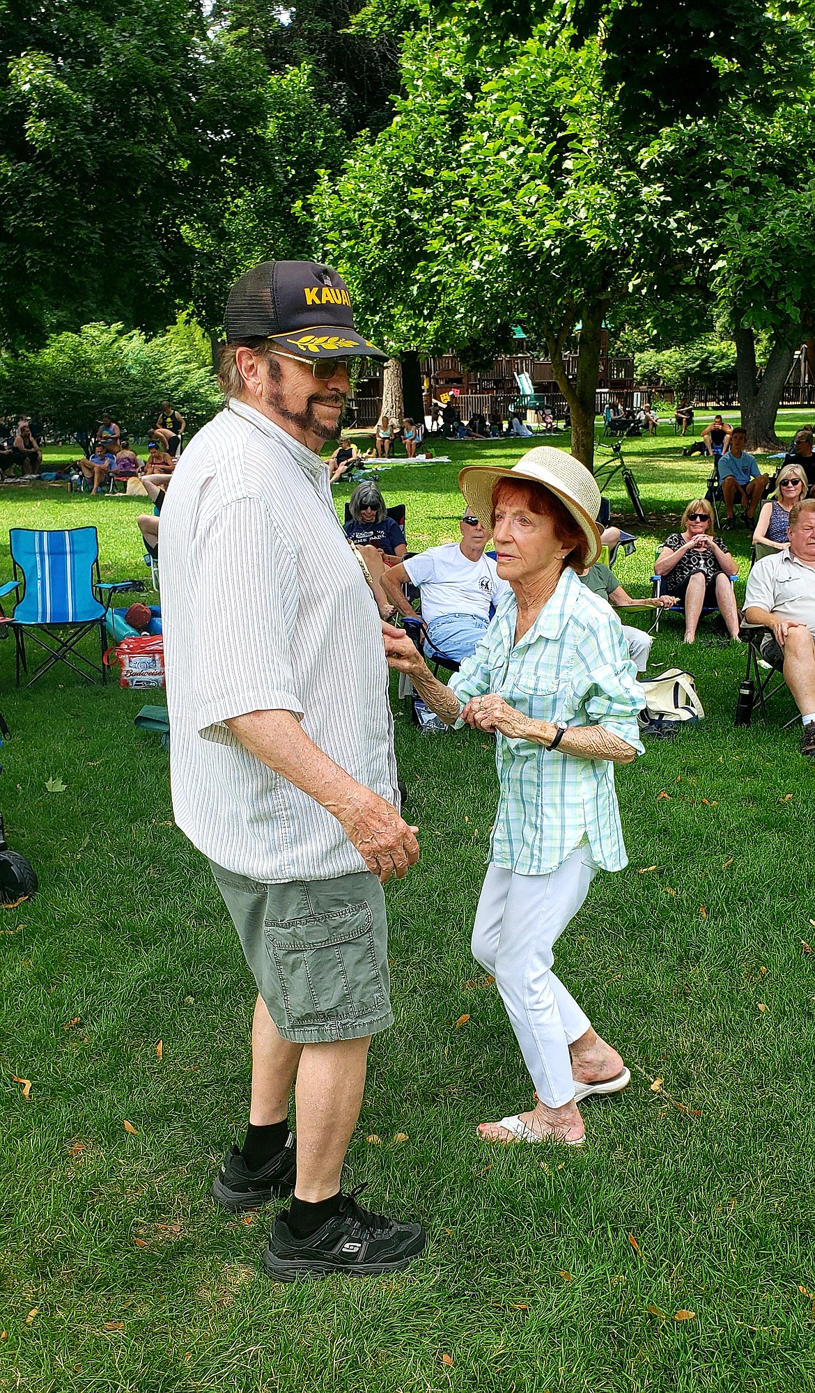 Vivian Russell and Larry Pence dance during a memorial singer-songwriter panel Sunday honoring Chris Guggemos, founder of the local free summer concert series.