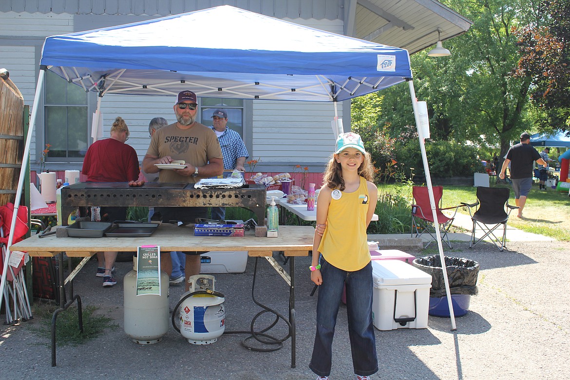 Bess Baker was helping her dad, Russ, in the Alberton Ridge Runners Saddle Club selling grilled hotdogs. The organization is steeped in equine training for kids and also very community minded helping with events throughout the year. (Monte Turner/Mineral Independent)