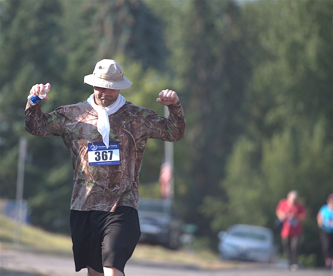 Daniel Oraivej celebrates completion of the four-mile Buffalo Run course on Saturday during Good Old Days in St. Ignatius. (Max Dupras/Leader)