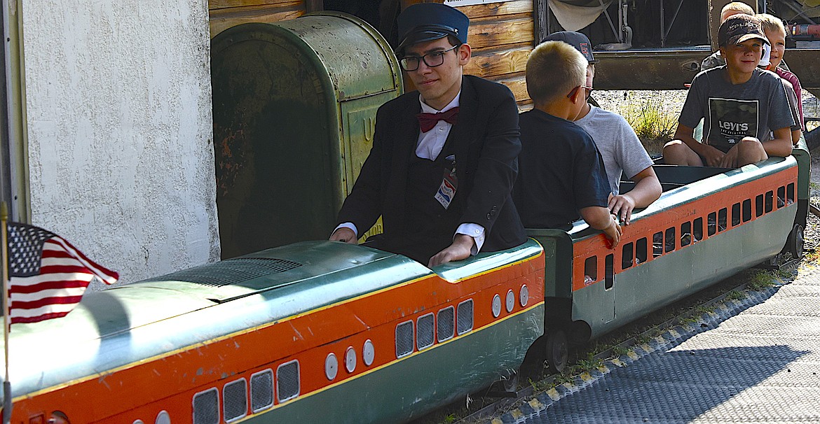 Engineer Zach Wild, great grandson of Miracle of America CEO Gil Mangels , takes the Empire Builder and a load of kids on a ride during Live History Days. (Berl Tiskus/Leader)