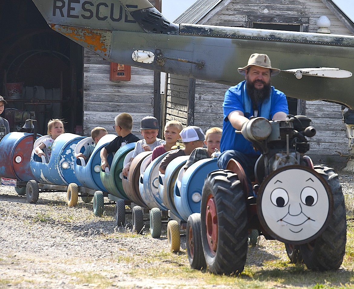 A group of kids at Live History Days get a ride on the barrel train, always a popular attraction because each kid gets a bell to ring. (Berl Tiskus/Leader)