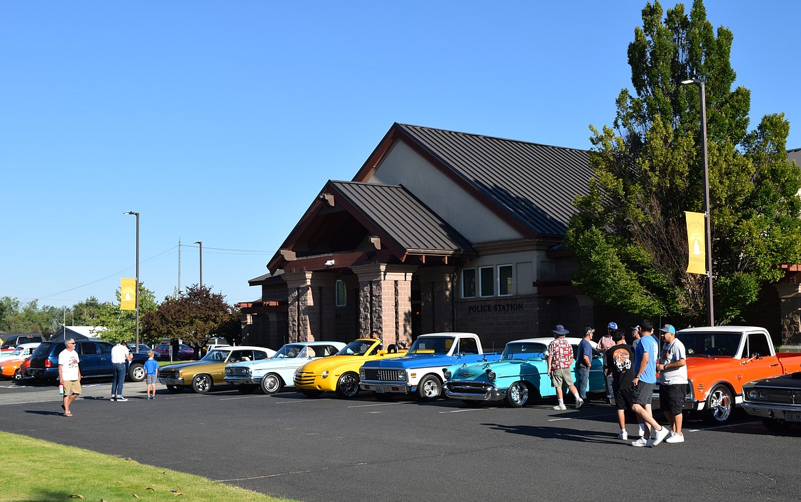 Car owners show off their classic and contemporary vehicles in front of City Hall on Friday evening during Othello’s All Cities Class Car Club car show, a preview of the rows of cars that would fill Kiwanis Park on Saturday.