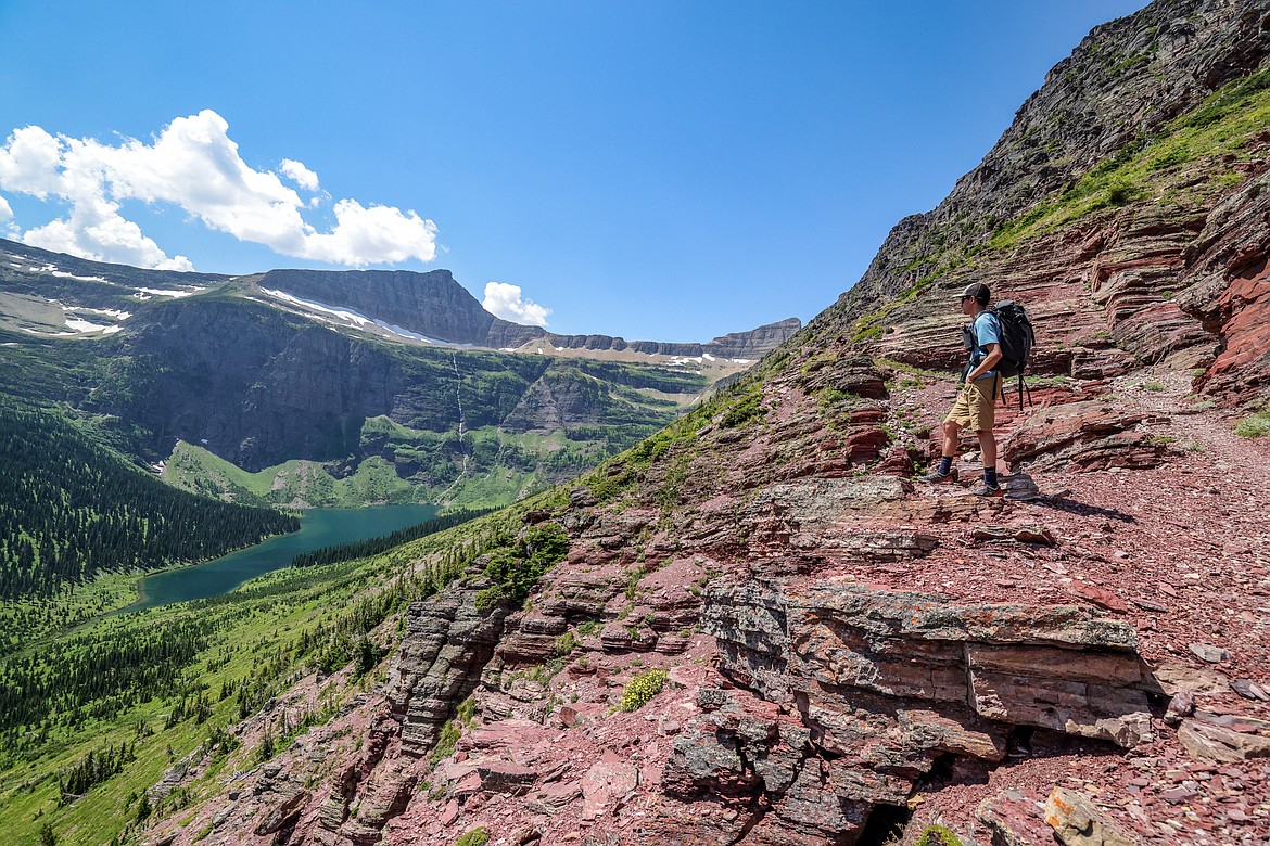 A hiker stands above Medicine Grizzly Lake, the headwaters of the Gulf of Mexico, on the trail to Triple Divide. (JP Edge photo)