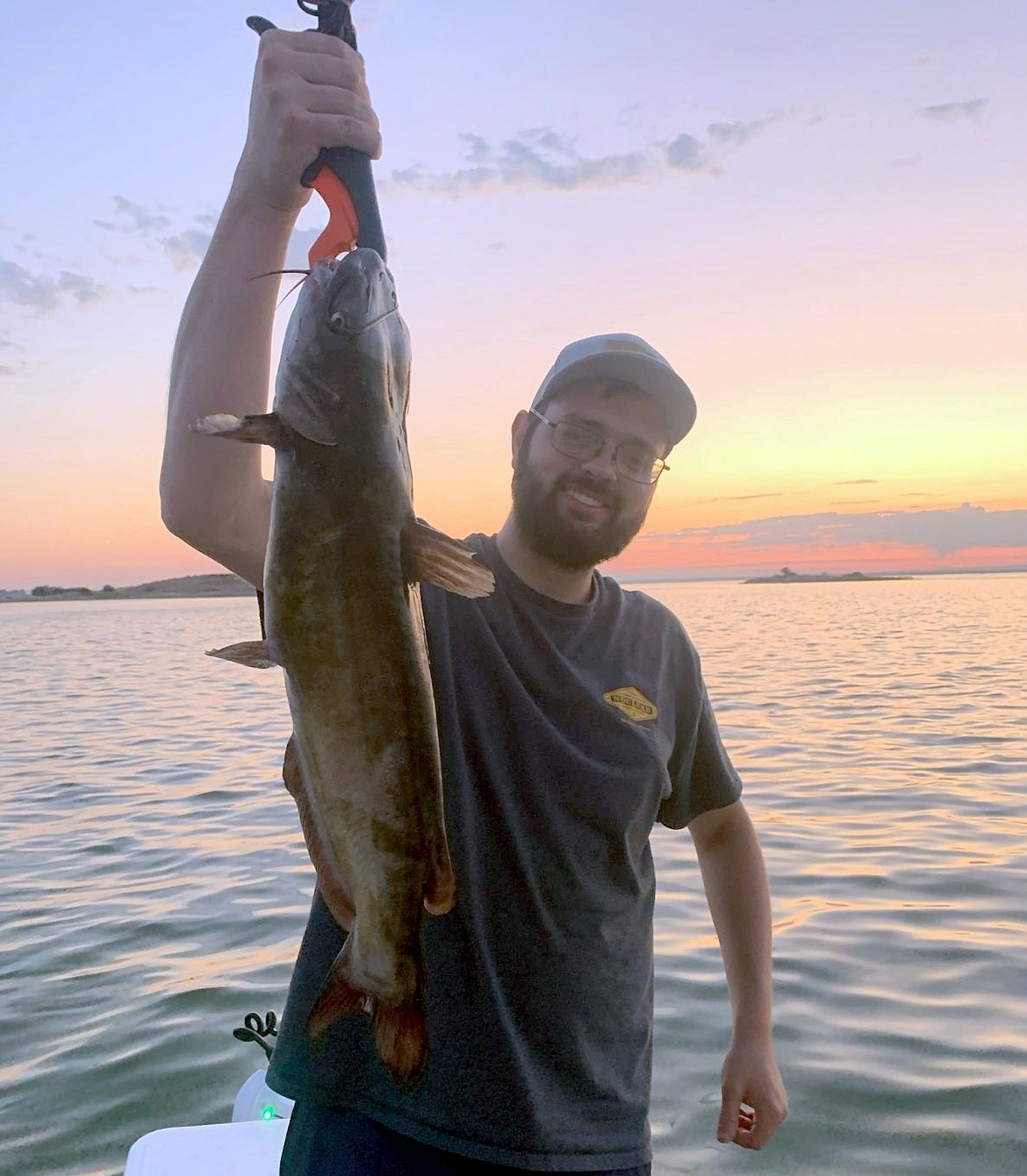 Jason Vosk holds up a a 7-pound, 10-ounce channel catfish caught while trolling a crankbait out on Potholes Reservoir.