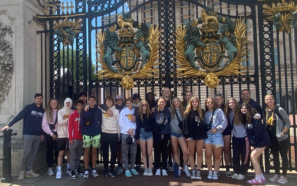 The NBC boys and girls travel basketball teams pose for a photo outside the gates of the Buckingham Palace.