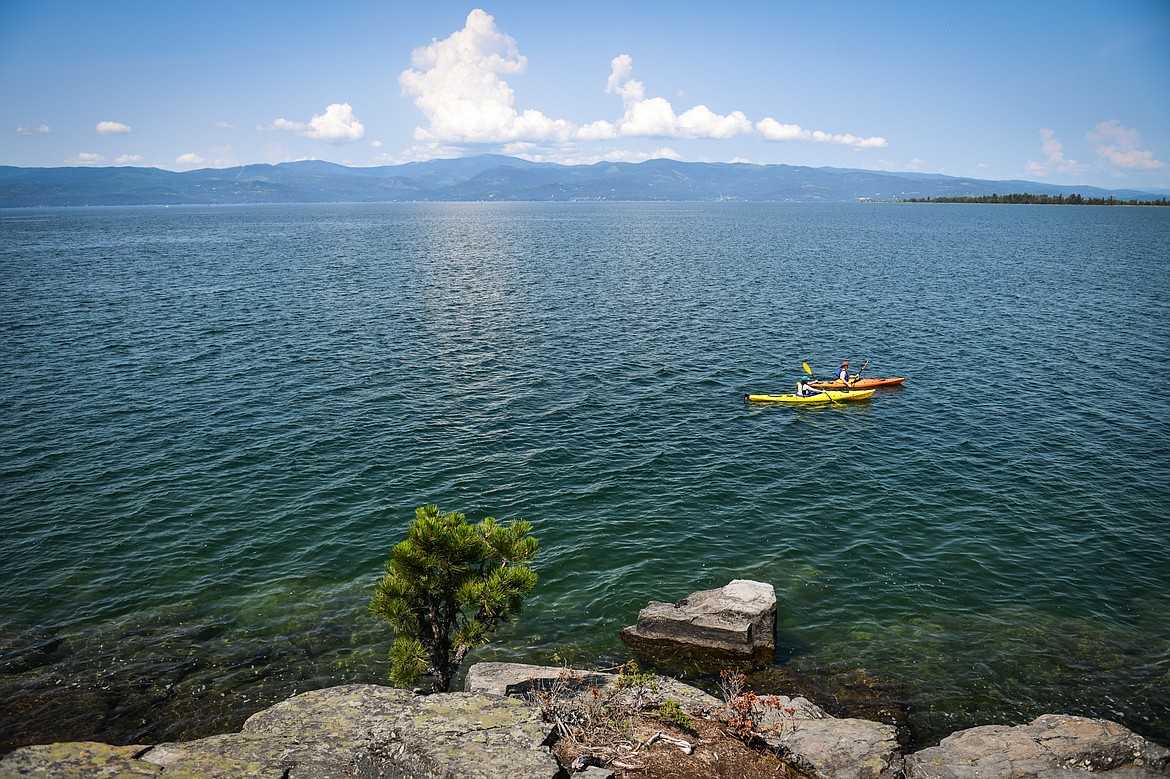 Two kayakers paddle along the shore of the Wayfarers Unit of Flathead Lake State Park in Bigfork on Wednesday, June 28. (Casey Kreider/Daily Inter Lake)