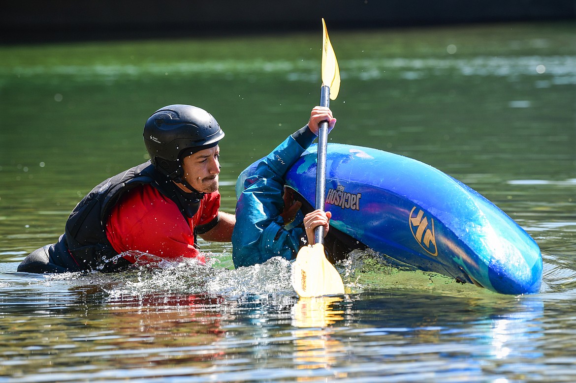 Dave Meyers, left, with Montana Kayak Academy, instructs Daily Inter Lake reporter Adrian Knowler on performing a roll at the Teakettle Fishing Access Site in Columbia Falls on Wednesday, July 19. (Casey Kreider/Daily Inter Lake)