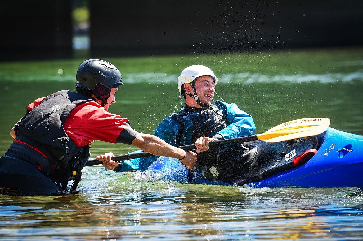 Dave Meyers, left, with Montana Kayak Academy, instructs Daily Inter Lake reporter Adrian Knowler on performing a roll at the Teakettle Fishing Access Site in Columbia Falls on Wednesday, July 19. (Casey Kreider/Daily Inter Lake)