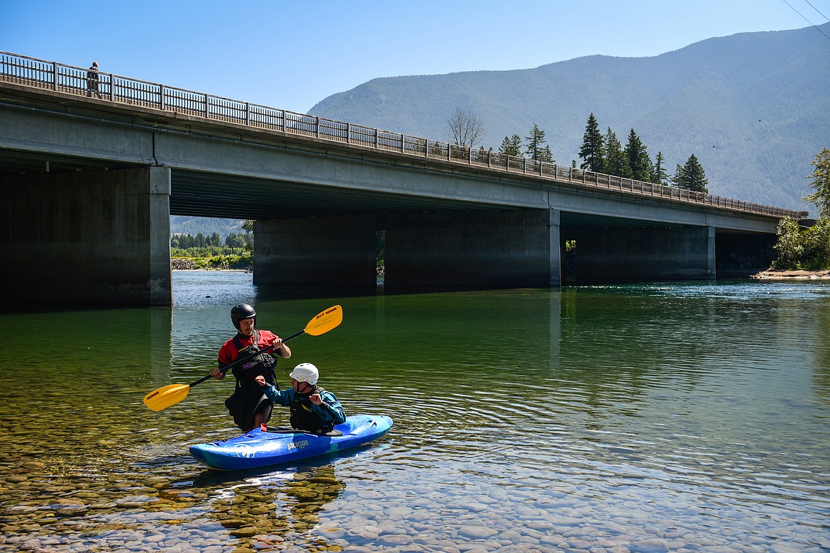 Dave Meyers, left, with Montana Kayak Academy, gives a lesson to Daily Inter Lake reporter Adrian Knowler at the Teakettle Fishing Access in Columbia Falls on Wednesday, July 19. (Casey Kreider/Daily Inter Lake)