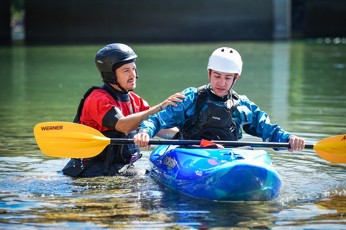 Dave Meyers, left, with Montana Kayak Academy, instructs Daily Inter Lake reporter Adrian Knowler on performing a roll at the Teakettle Fishing Access Site in Columbia Falls on Wednesday, July 19. (Casey Kreider/Daily Inter Lake)