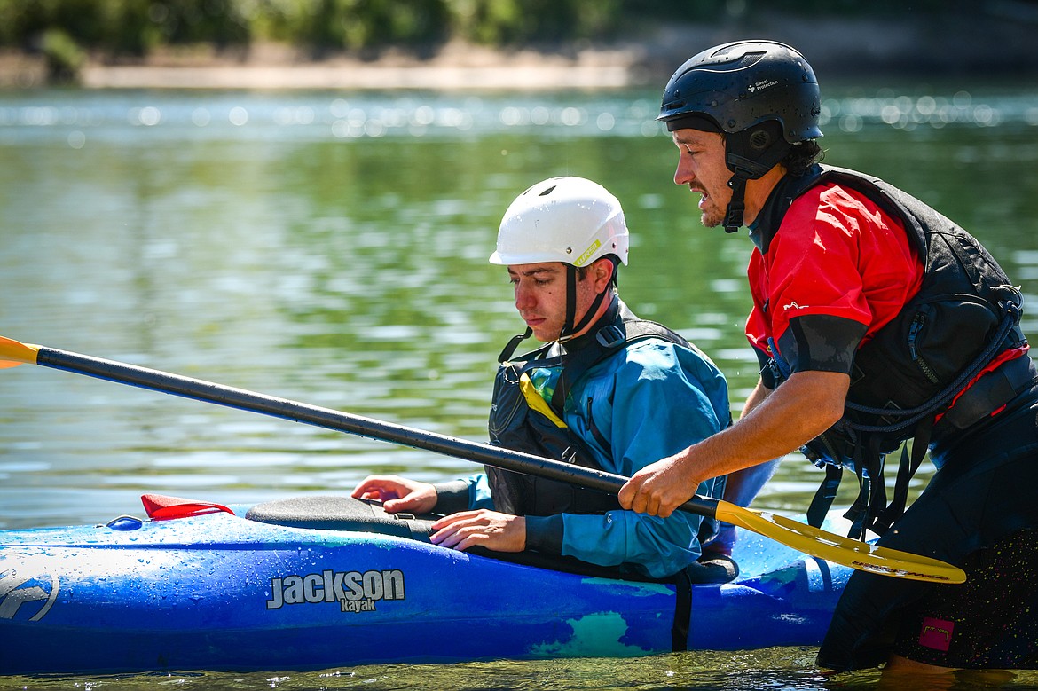 Dave Meyers, right, with Montana Kayak Academy, instructs Daily Inter Lake reporter Adrian Knowler at the Teakettle Fishing Access Site in Columbia Falls on Wednesday, July 19. (Casey Kreider/Daily Inter Lake)