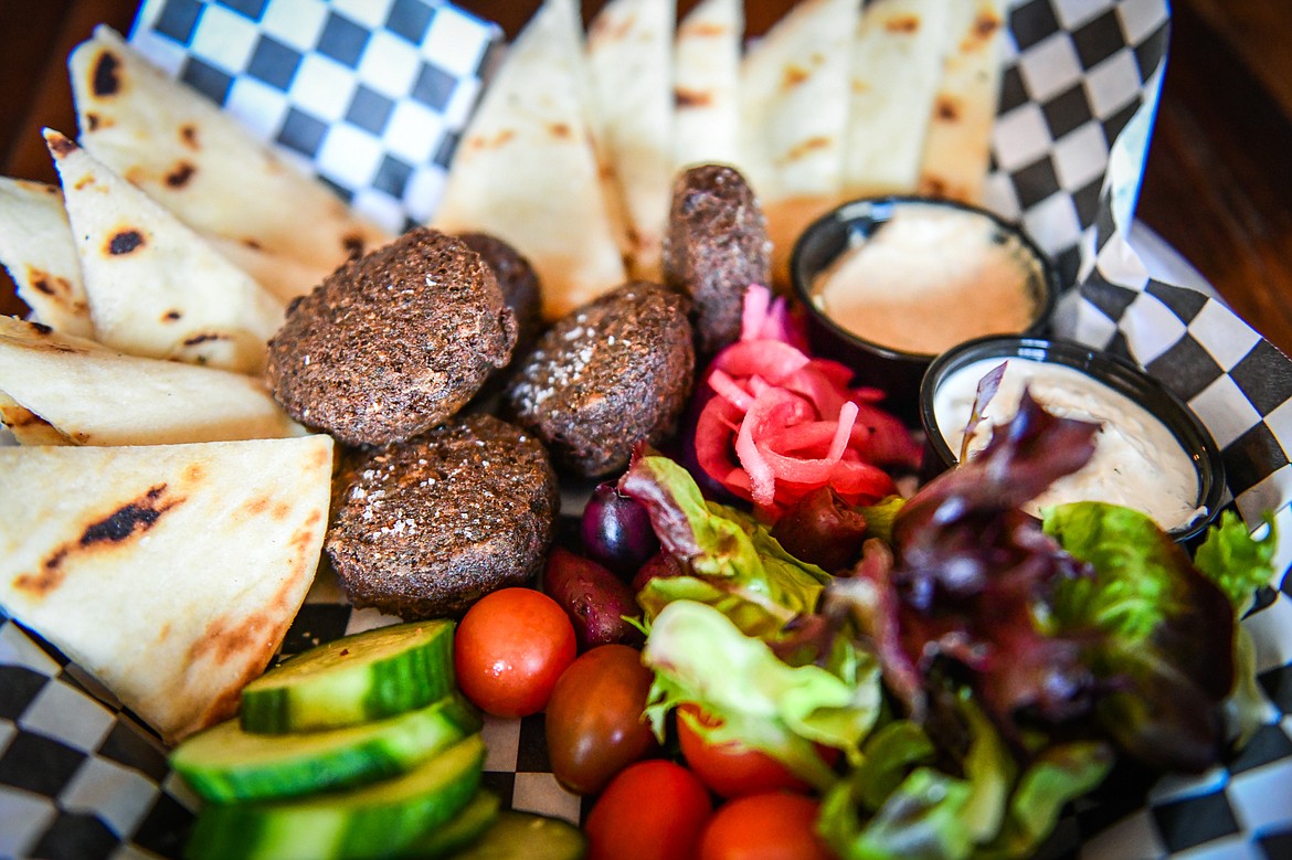 The Mediterranean Platter featuring house falafel, tzatziki, tomato, pickled red onion, Kalamata olives, cucumber, hummus and pita wedges at Sacred Eats inside Sacred Waters Brewing Company on Wednesday, July 19. (Casey Kreider/Daily Inter Lake)