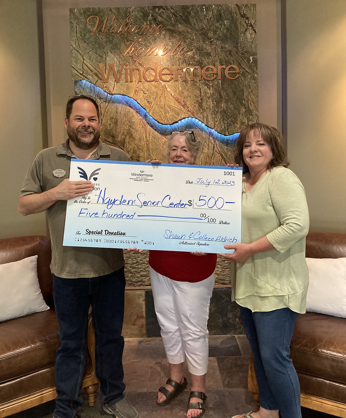 Hayden Senior Center board treasurer Kathy Verburg, center, on July 12 accepts a $500 donation from Shawn Aldrich, left, and Colleen Aldrich of Windermere Coeur d'Alene Realty.