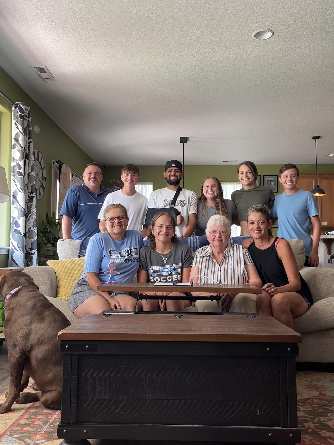 Moses Lake alumna Joelee Green-Cerrillo, front row center left, smiles with family at a ceremonial signing to play college soccer at Columbia Basin College.