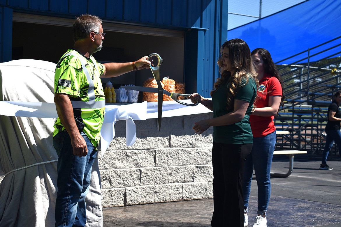 Othello Parks and Recreation Coordinator Valerie Hernandez, right, and Othello Public Works Director Curt Carpenter, left, cut the ceremonial ribbon on Othello’s upgrades to the Lions Park Athletic Complex.