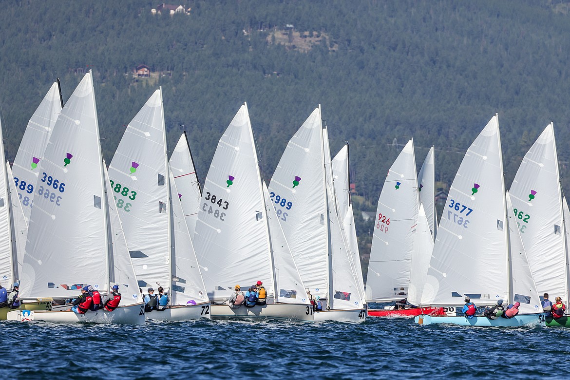 Thistle class sailboats leave the startline on Wednesday, July 19 on the third day of the 77th Thistle Nationals on Flathead Lake. The event was hosted by the North Flathead Yacht Club. It was the first time in over 30 years that the club hosted the nationals. (JP Edge/Hungry Horse News)