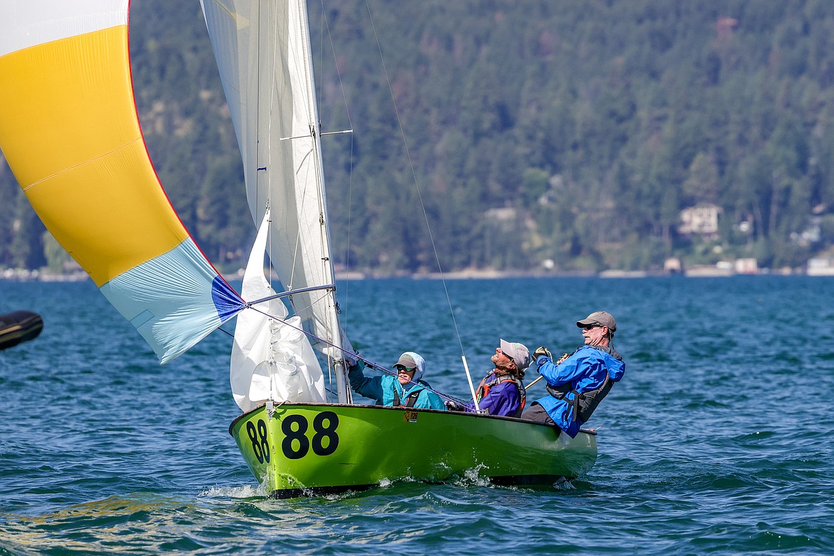 Kat Ingalls, George Michels and Phil Healey of Kalispell fly their spinnaker in the 77th Thistle Nationals on Flathead Lake. (JP Edge/Hungry Horse News)