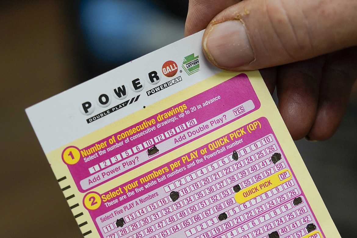 A person shows their scan card for their personal selection numbers for a ticket for a Powerball drawing on Nov. 7, 2022, at a convenience store in Renfrew, Pa. A winning ticket has been sold in California for Wednesday's drawing on July 19, 2023, for the Powerball jackpot worth $1 billion. (AP Photo/Keith Srakocic, File)