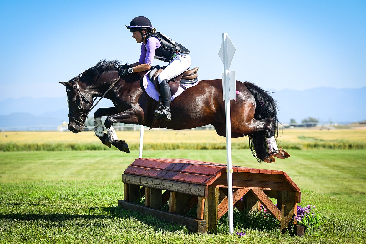 Madison Ritsch clears a jump on her horse Taylamor Penelope during Senior Open Novice C cross-country at The Event at Rebecca Farm on Thursday, July 20. (Casey Kreider/Daily Inter Lake)