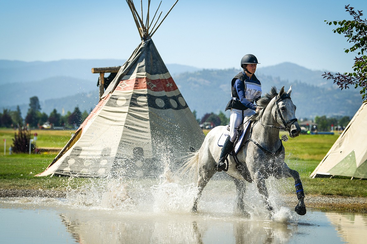 Emily Sloop rides her horse Sarcillo through a water feature during Senior Open Novice D cross-country at The Event at Rebecca Farm on Thursday, July 20. (Casey Kreider/Daily Inter Lake)