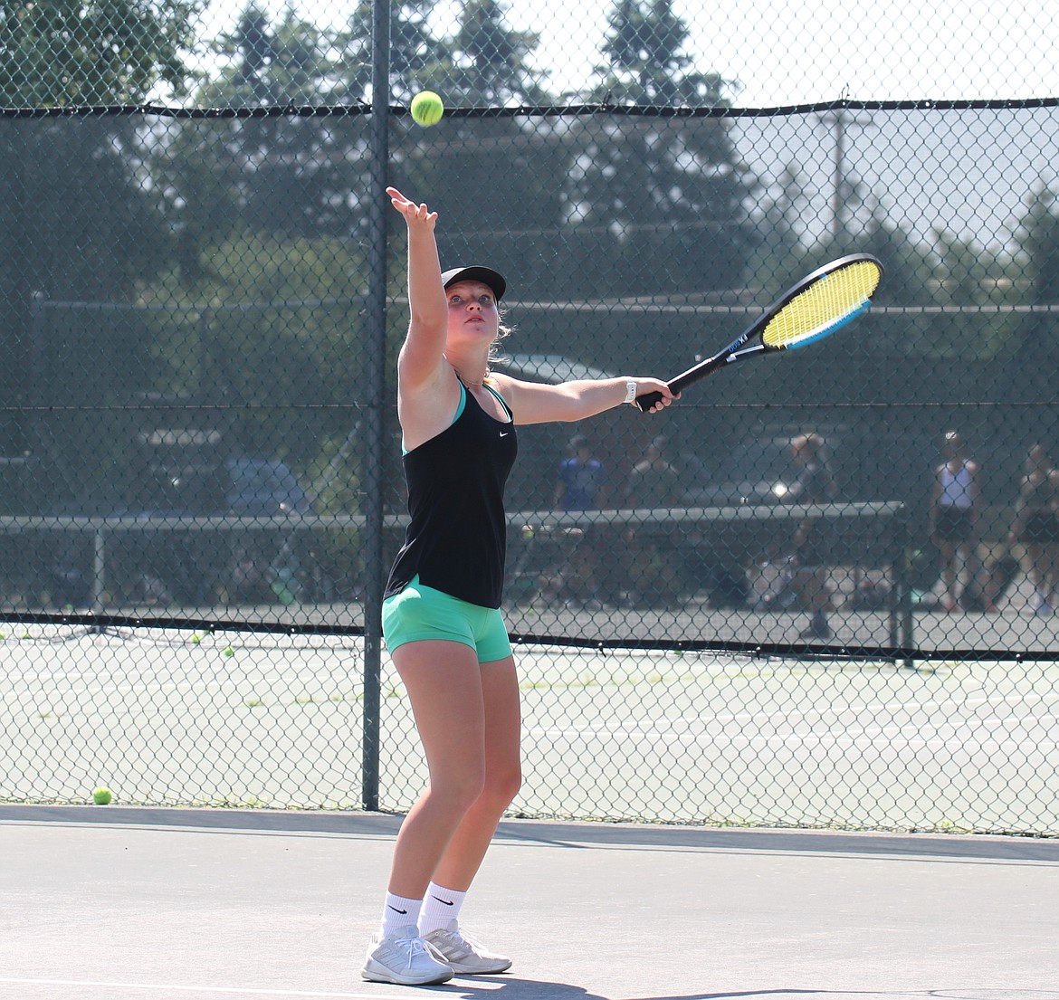 Aubrey Knowles tosses a ball into the air as she gets ready to serve.