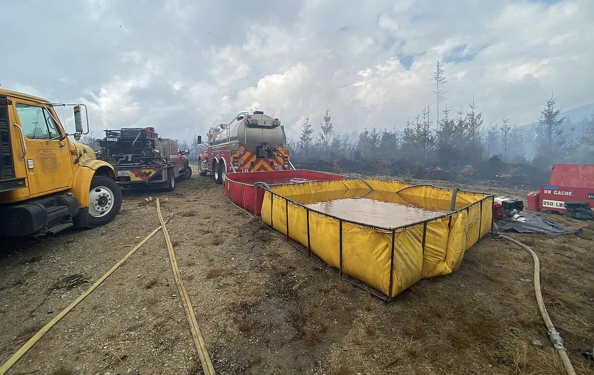 Crews haul water to the site of the Mountain Loop fire in Snohomish County Tuesday.