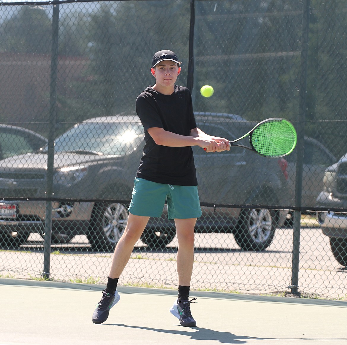 Jacob Dawson successfully returns a ball with a backhand swing.