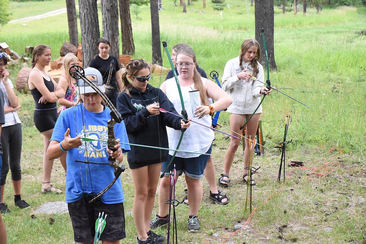 From left, are Teighler Parker, Brynn DeShazer, Alexandra Boone and Rylee Delmas. Boone, a Libby Public Schools teacher, instructed the students how to shoot a bow and arrow during the Kootenai Outdoor Adventure Program. (Scott Shindledecker/The Western News)