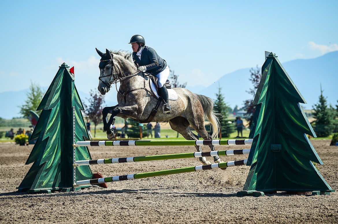 Valerie Schwartz rides Something Blue through the arena during Senior Open Novice C show jumping at The Event at Rebecca Farm on Friday, July 21. (Casey Kreider/Daily Inter Lake)