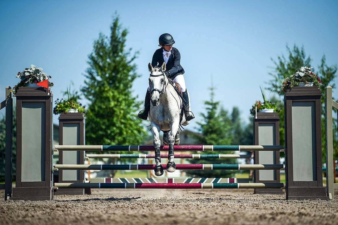 Lydia McAllister rides Astra through the arena during Senior Open Novice C show jumping at The Event at Rebecca Farm on Friday, July 21. (Casey Kreider/Daily Inter Lake)