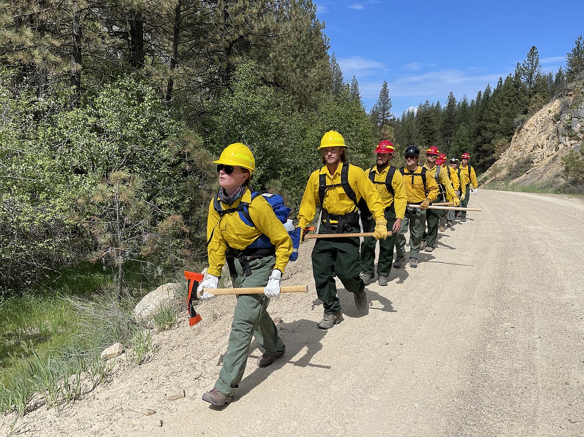 Wildland firefighter recruits practice techniques during a training in May. Wildfire training is separate from local fire departments that are trained to fight structure fires. Although the goals to prevent fire destruction are the same in many ways, that’s where the similarities end.