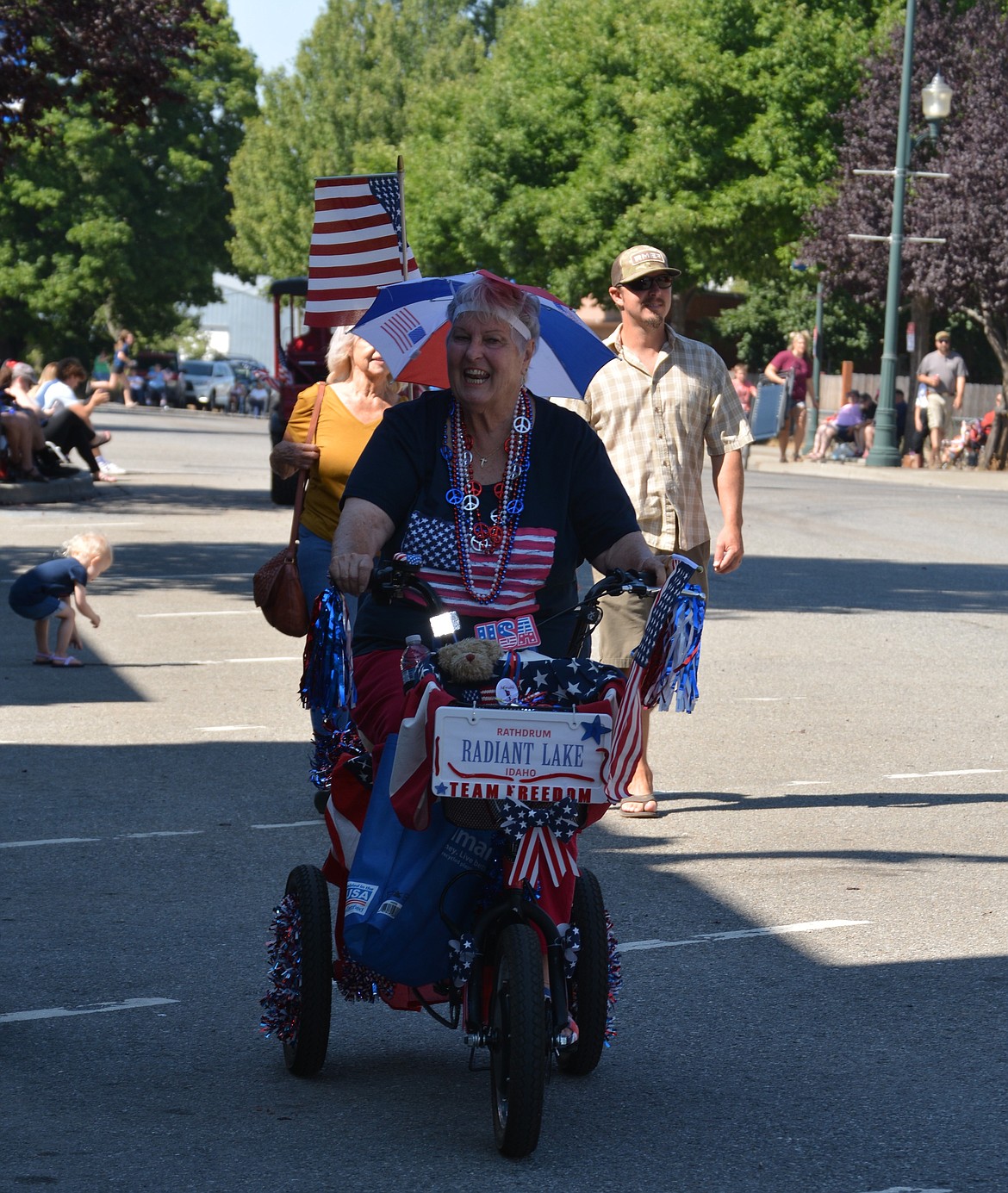 A woman on a three wheeler goes down Main Street wearing red, white, and blue during the Rathdrum Days Parade. (CAROLYN BOSTICK/Press)