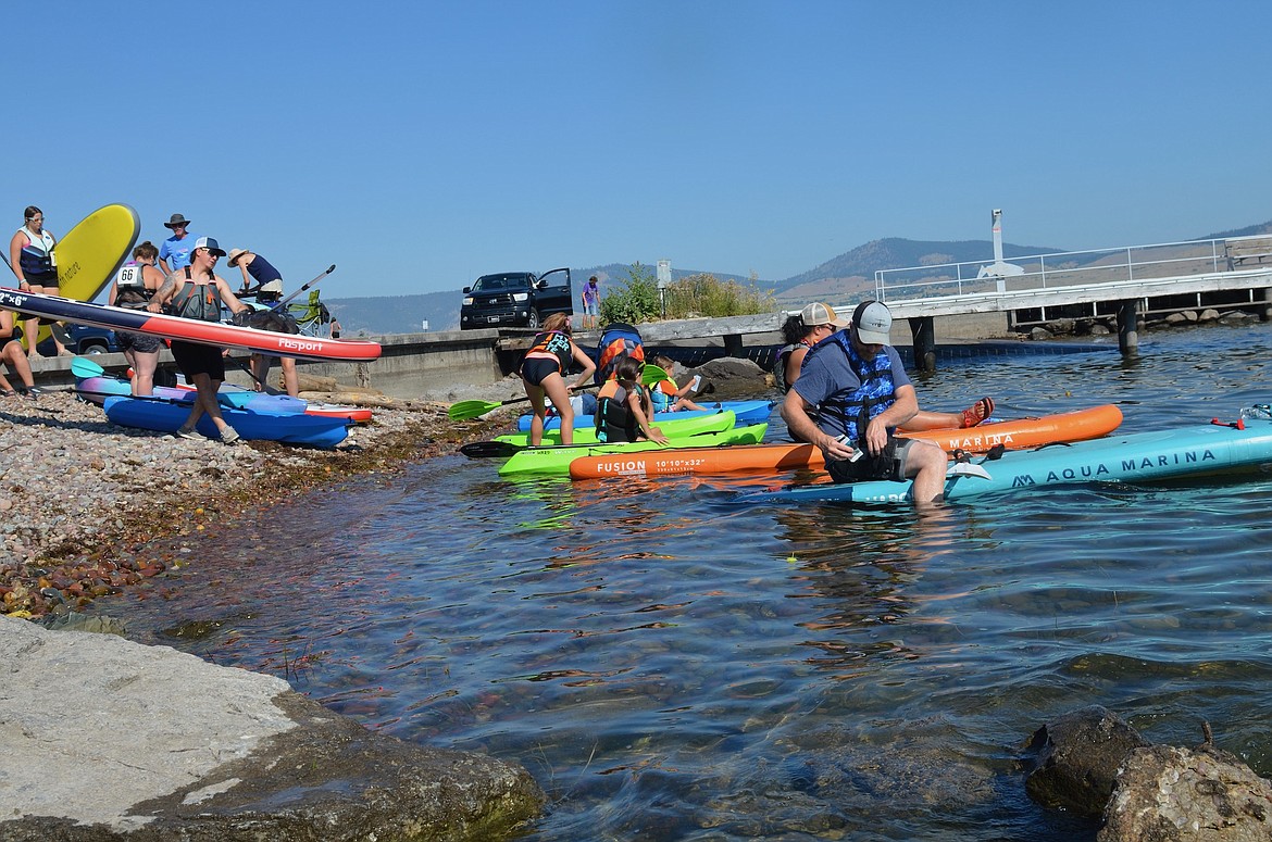 A group of Poker Paddle participants launches from KwaTaqNuk Resort. (Kristi Niemeyer/Leader)